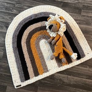 New handmade rainbow blanket and lion snuggler crocheted by me.